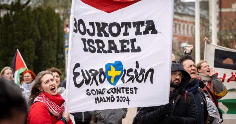 Participants hold up flags and placards during a demonstration outside the City Hall in Malmö, Sweden on April 10, 2024 in connection with the municipal board's consideration of a citizens' proposal to stop Israel's participation in the Eurovision Song Contest. The demo was organised by the citizens' initiative 'No Eurovision in Malmö with Israel's participation'. (Photo by Johan NILSSON / TT News Agency / AFP) / Sweden OUT (Photo by JOHAN NILSSON/TT News Agency/AFP via Getty Images)