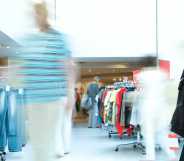 Blurred customer in a clothing store.