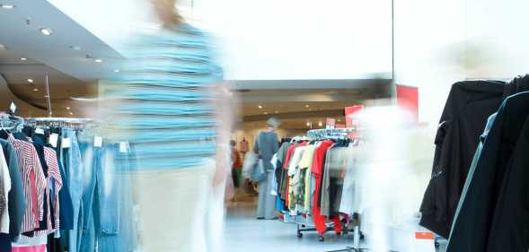 Blurred customer in a clothing store.