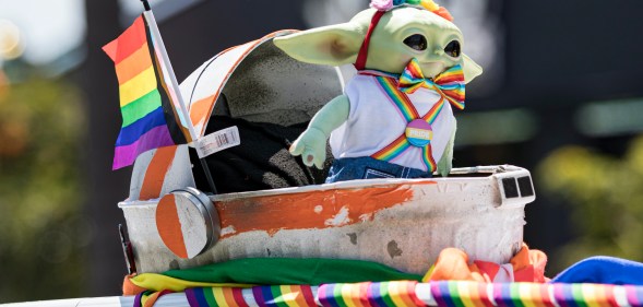 Photo taken at San Diago Pride showing Grogu from The Mandalorian in Pride themed rainbow outfit