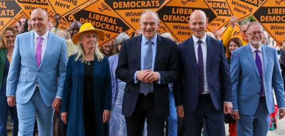 Leader of the Liberal Democrats Ed Davey (C) walks in front of Lib Dem supporters with prospective parliamentary candidates Cameron Thomas, Tewkesbury (L), Roz Savage, South Cotswolds (2L), Max Wilkinson, Cheltenham (2R) and Paul Hodgkinson, North Cotswolds (R) while campaigning ahead of the forthcoming general election on May 23, 2024 in Cheltenham, England.