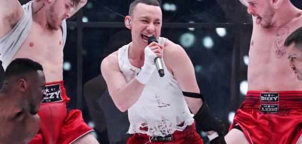 Olly Alexander representing Great Britain with the entry 'Dizzy' performs on stage during the first rehearsal for the first semi-final of the 68th edition of the Eurovision Song Contest (ESC) at the Malmo Arena, in Malmo, Sweden, on May 6, 2024. A week of Eurovision Song Contest festivities kicked off Saturday, on May 4, in the southern Swedish town of Malmo, with 37 countries taking part. The first semi-final takes place on Tuesday, May 7, the second on Thursday, May 9, and the grand final concludes the event on May 11. (Photo by Jessica GOW / TT News Agency / AFP) / Sweden OUT