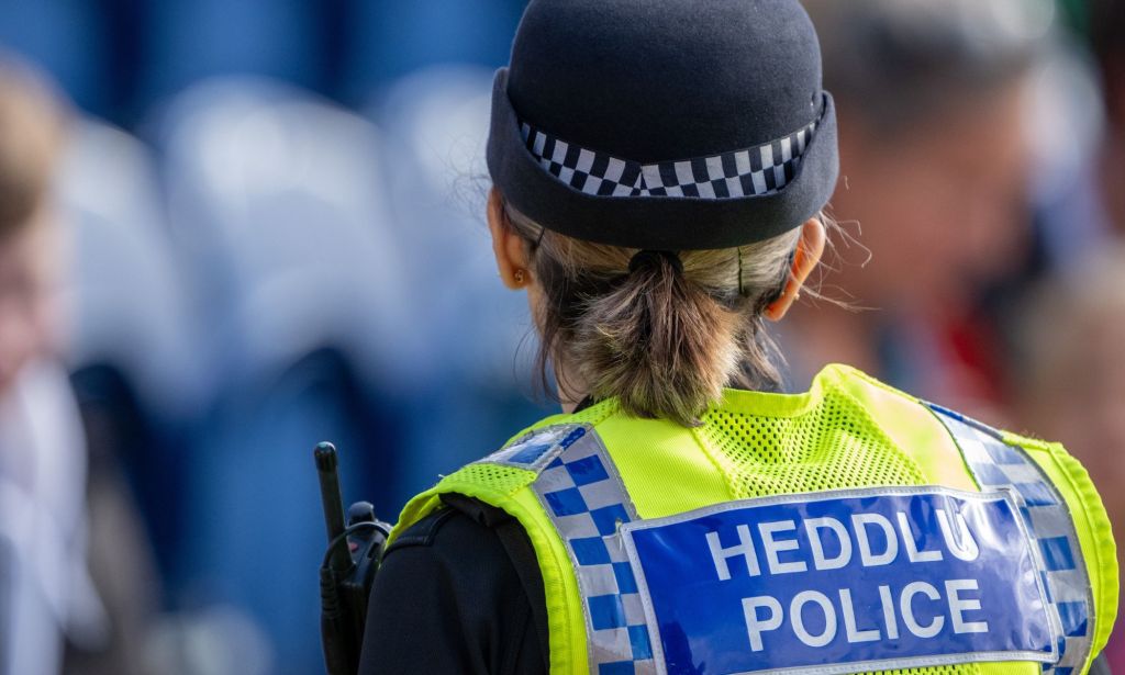 The back of a Wales Police officer.