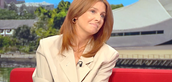 Stacey Dooley on BBC Breakfast, she's wearing a white blazer and sitting on a red sofa