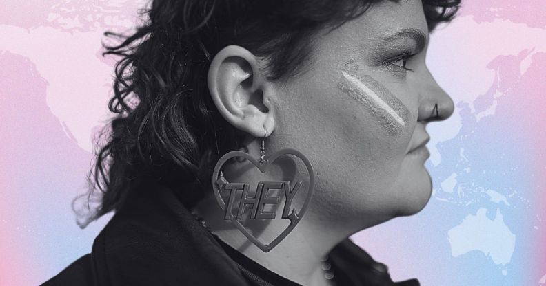 The side profile of a person infront of a world map in the trans colours.