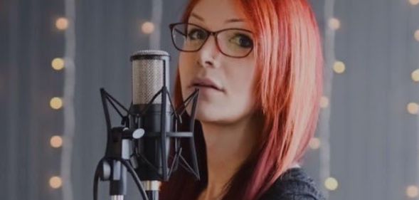 Voice Actress, Zoey Alexandria, who voices The Unknown in Dead By Daylight, in front of a microphone