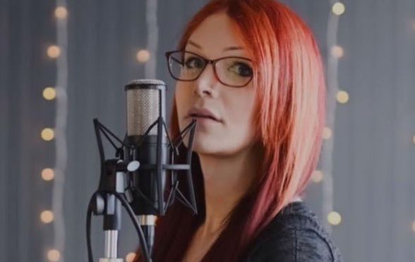Voice Actress, Zoey Alexandria, who voices The Unknown in Dead By Daylight, in front of a microphone
