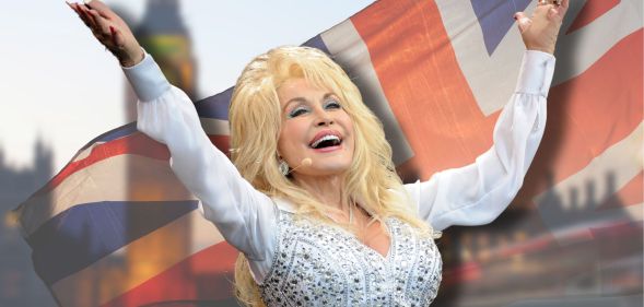Dolly Parton with her arms in the air in a white bejazzled outfit. She is against a blurred union jack.