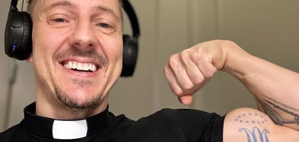 A gay priest flexing his arm