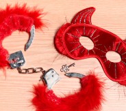 Fetish gear including furry red handcuffs and a devil mask