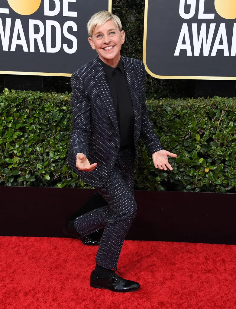 Ellen DeGeneres arrives at the 77th Annual Golden Globe Awards smiling on the red carpet.