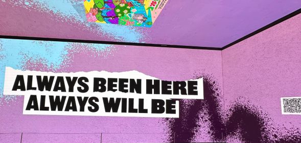 This is an image of an immersive experience. There is a purple background and text in black over white that says 'Always been here, always will be'