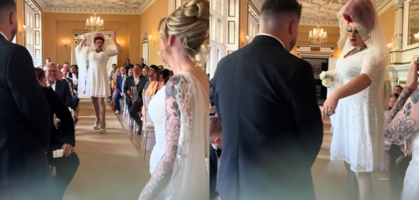 The drag bride tried to snatch away the husband-to-be. (@mwhitephotograph/TikTok)