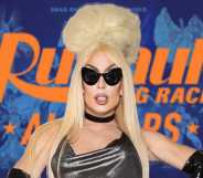 Alaska in front of the promo for All Stars 9