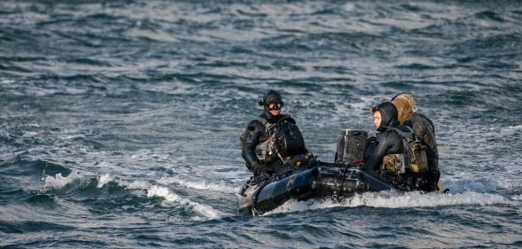 3 navy seals sitting in a boat