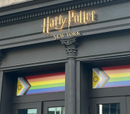 A shopfront bearing the Harry Potter logo and a Progress Pride flag