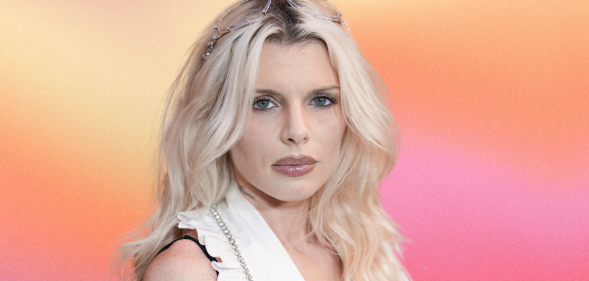 Julia Fox against a pink orange background.