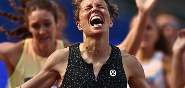Nikki Hiltz, with their eyes closed, screams in victory after winning the 1500m race.