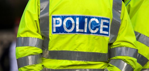 The back of a high-visibility Police jacket.