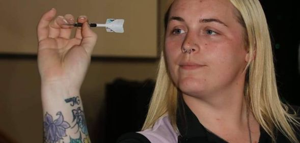 Samantha Lewis throwing a dart.