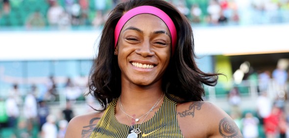 Sha'Carri Richardson possing with a smile after she won her race