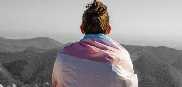A Trans teen in a trans Pride flag