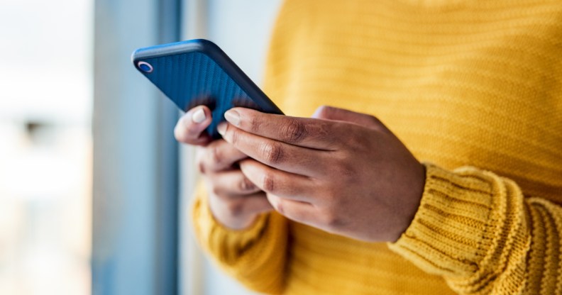 Shot of an unrecognizable woman using a mobile phone indoors