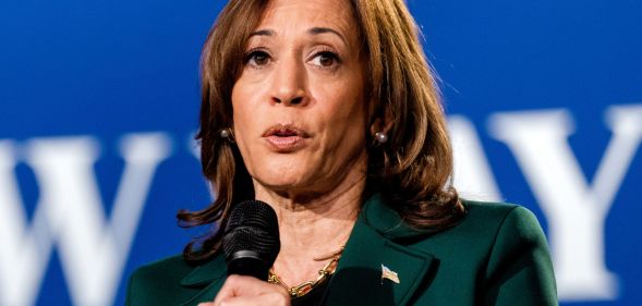 Kamala Harris speaking into a microphone.