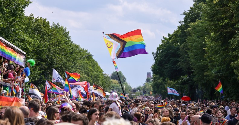 Progress inclusive Pride Flag flying at a parade