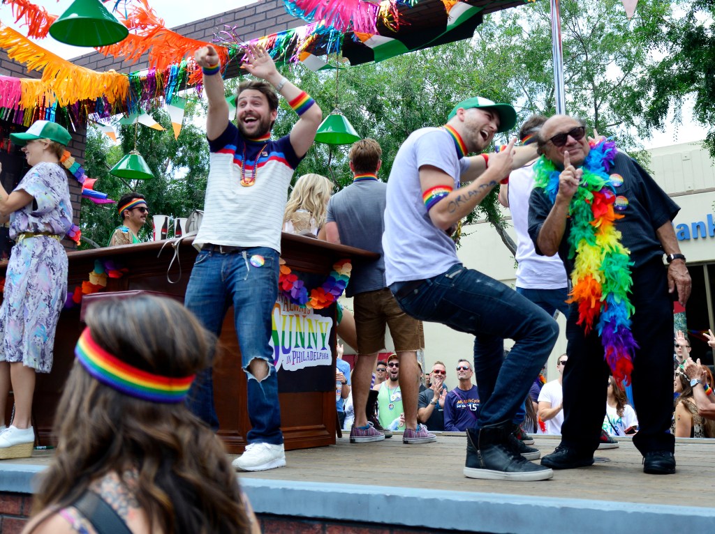Danny Devito posing with fans