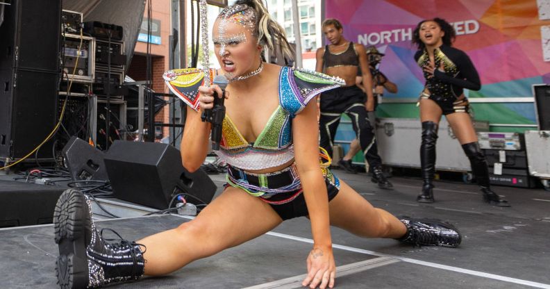 JoJo Siwa jumps in the air and drops into the splits during the Chicago Pride Fest on June 22, 2024 in Chicago, Illinois