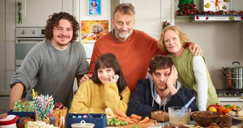 The Brockman family taking a family photo in the kitchen