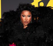 Tayce attends the MTV EMAs 2024. Dressed in a big black feathered shoulder piece.