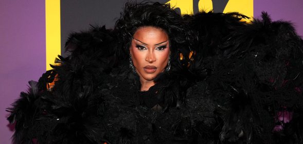 Tayce attends the MTV EMAs 2024. Dressed in a big black feathered shoulder piece.