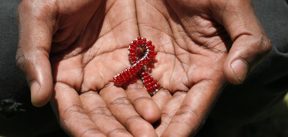 beaded AIDS symbol in hands