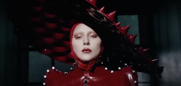 Lady Gaga in a red spiked latex hat in the music video for new single 'Abracadabra'.