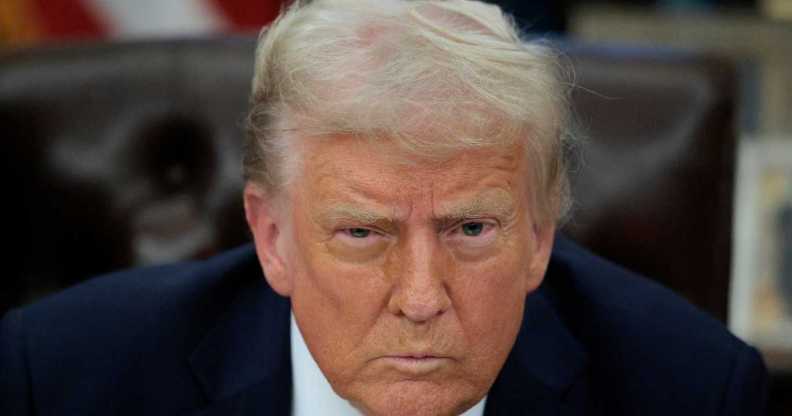 President Donald Trump talks to reporters after signing an executive order.