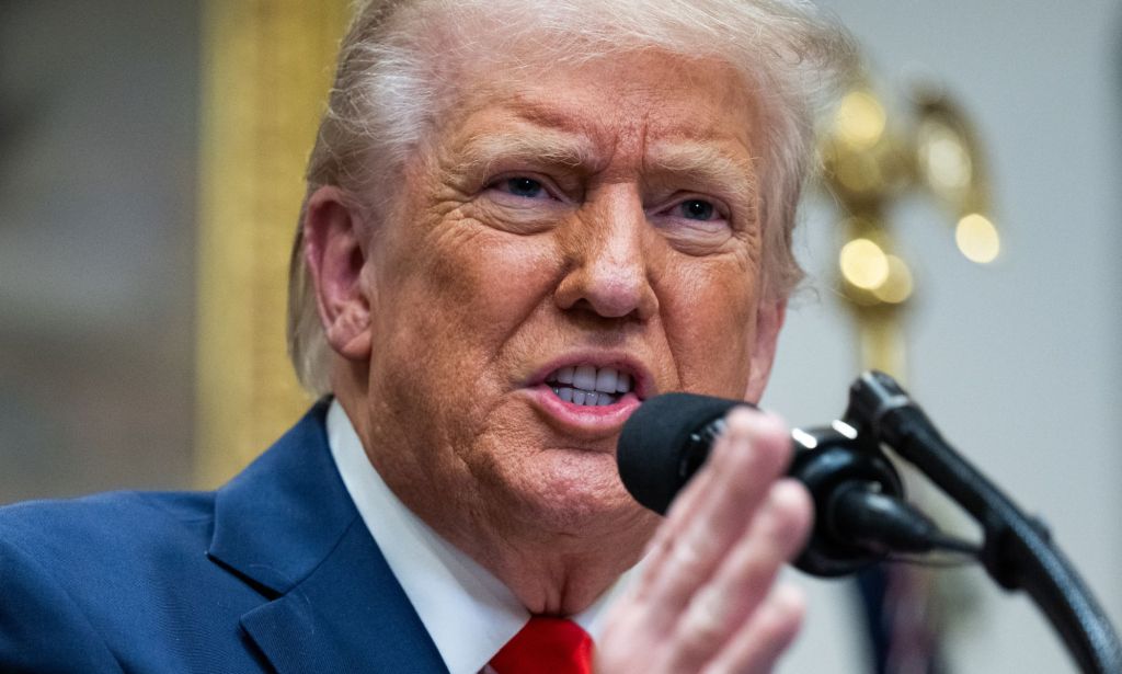 Donald Trump speaking into a microphone.