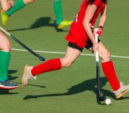 People playing with hockey sticks.