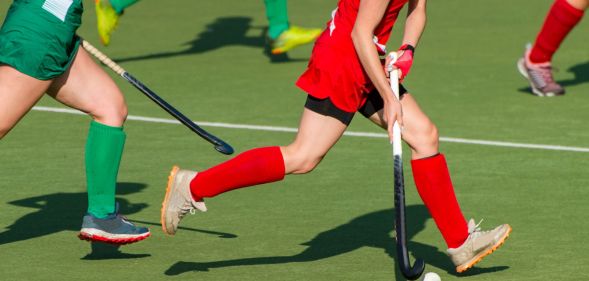 People playing with hockey sticks.