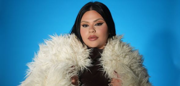 Malta's Eurovision entrant Miriana Conte in a white fur coat against a blue background.