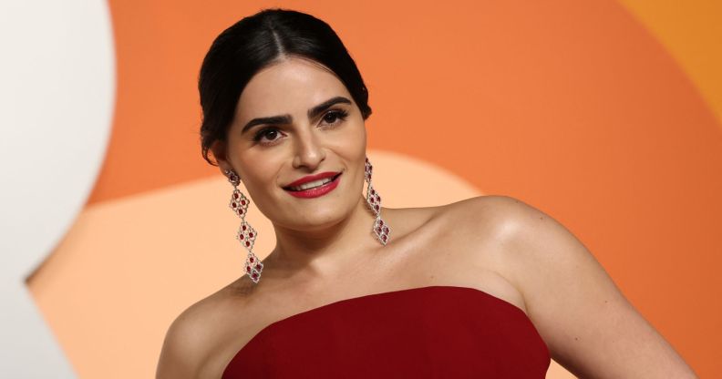 Actress Nava Mau seen wearing a red strapless dress and dangly earrings