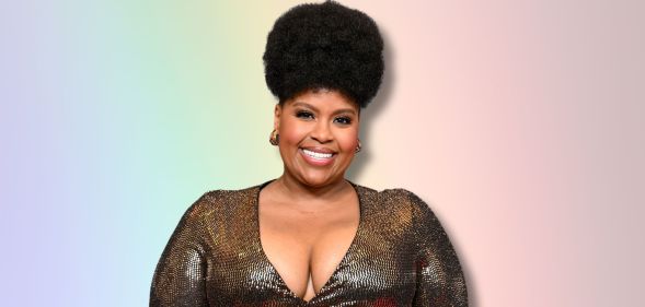 The White Lotus star Natasha Rothwell smiles against a rainbow background.