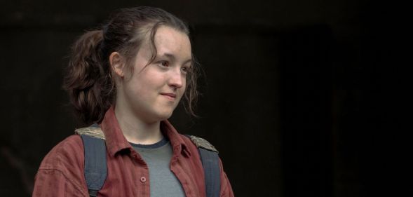 Bella Ramsey in a red shirt and wearing a backpack in role as Ellie in The Last of Us