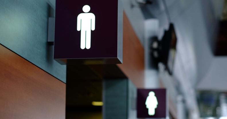 Two bathroom stall signs.