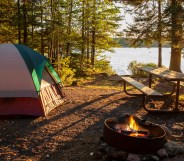 Campsite on lake in northern Minnesota with campfire at sunset