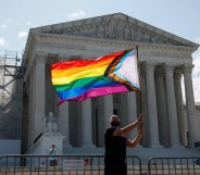 WASHINGTON, DC - JUNE 26: Same-sex marriage supporter Vin Testa, of Washington, DC, waves a LGBTQIA pride flag in front of the U.S. Supreme Court Building as he makes pictures with his friend Donte Gonzalez to celebrate the anniversary of the United States v. Windsor and the Obergefell v. Hodges decisions on June 26, 2023 in Washington, DC. Today marks the 8th anniversary of the Supreme Court's ruling in the Obergefell v. Hodges case that guaranteed the right to marriage for same-sex couples.