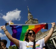 A participant holds a rainbow flag before the procession in Warsaw, Poland.