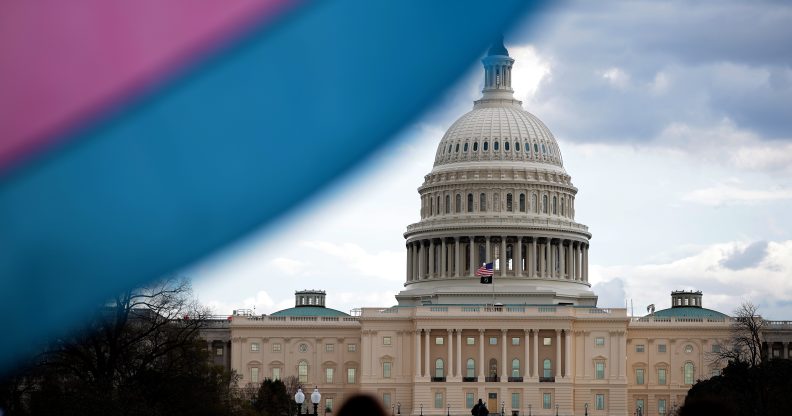 The U.S. Capitol Building is seen behind the Transgender Pride Flag during the Trans Day Of Visibility rally.