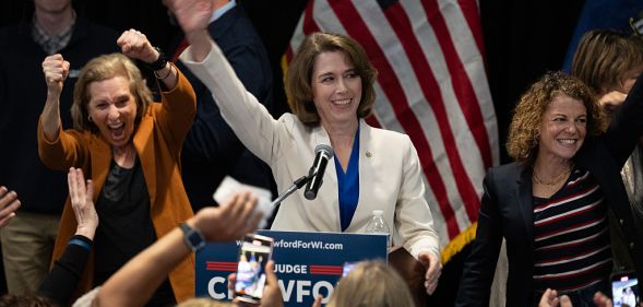 Dane County Circuit Court Judge Susan Crawford, flanked by Wisconsin Supreme Court justices, accepts victory in her race for Wisconsin Supreme Court justice on April 01, 2025 in Madison, Wisconsin. (Photo by Scott Olson/Getty Images)
